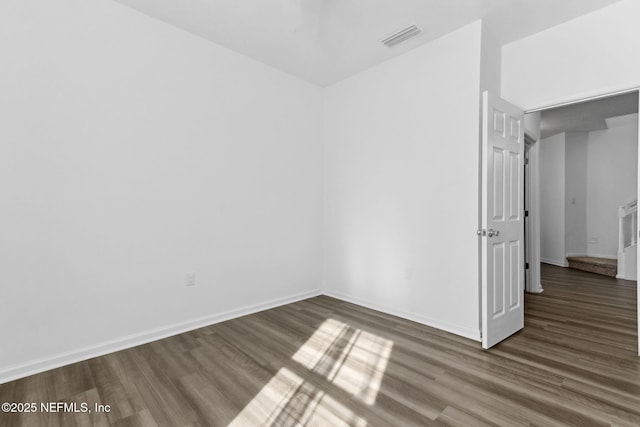 spare room with dark wood-type flooring