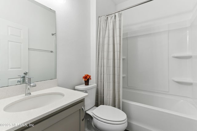 full bathroom featuring shower / bath combination with curtain, vanity, and toilet