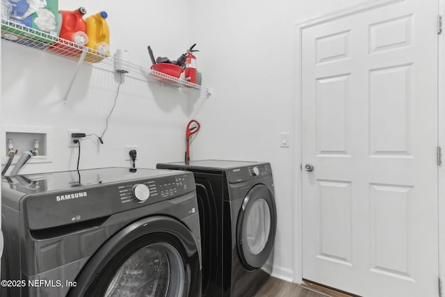 laundry area featuring dark hardwood / wood-style floors and washing machine and clothes dryer