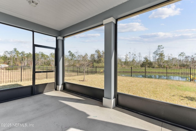 unfurnished sunroom featuring a water view and a healthy amount of sunlight