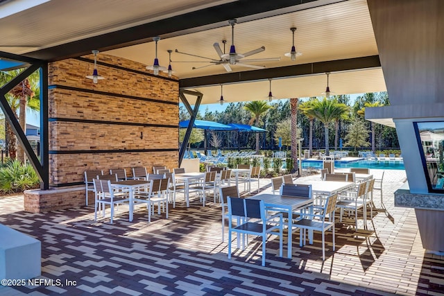 view of patio / terrace featuring ceiling fan and a community pool