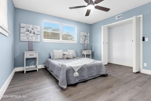 bedroom with ceiling fan and wood-type flooring