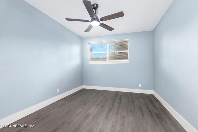 unfurnished room with ceiling fan and dark hardwood / wood-style flooring