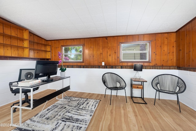 home office featuring wood walls and light wood-type flooring