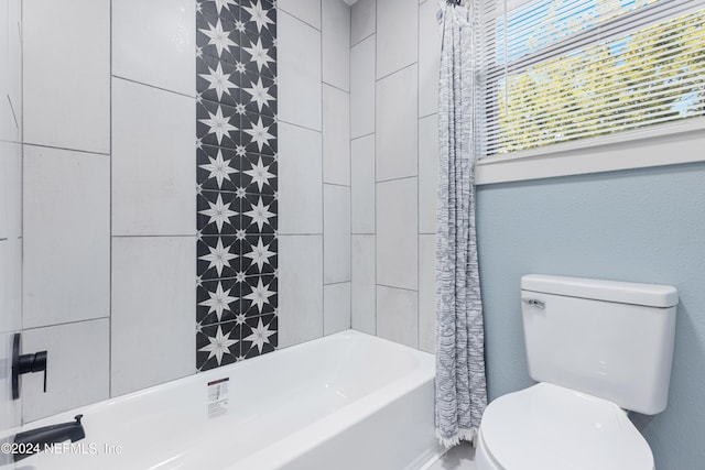 bathroom with shower / bath combo and toilet