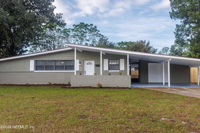 ranch-style house featuring a front yard and a carport