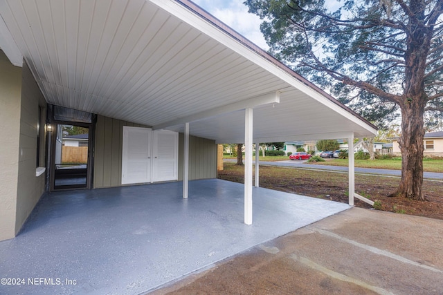 view of parking / parking lot featuring a carport