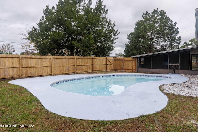 view of swimming pool featuring a sunroom