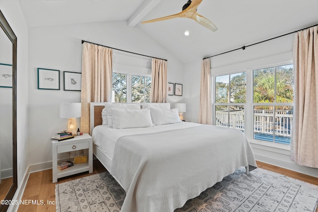 bedroom featuring vaulted ceiling with beams, ceiling fan, light hardwood / wood-style floors, and multiple windows