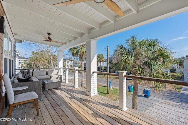 deck with an outdoor living space and ceiling fan