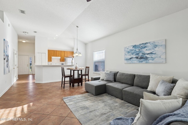 tiled living room featuring high vaulted ceiling, a chandelier, and a textured ceiling