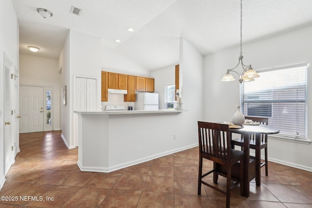 tiled dining space featuring a textured ceiling, high vaulted ceiling, a wealth of natural light, and a notable chandelier