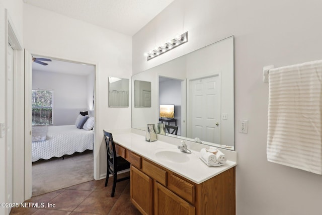 bathroom with tile patterned floors, vanity, and ceiling fan