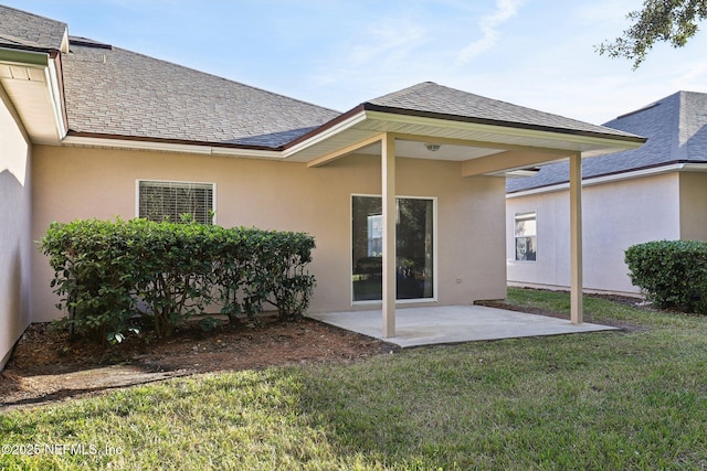 rear view of property featuring a yard and a patio area