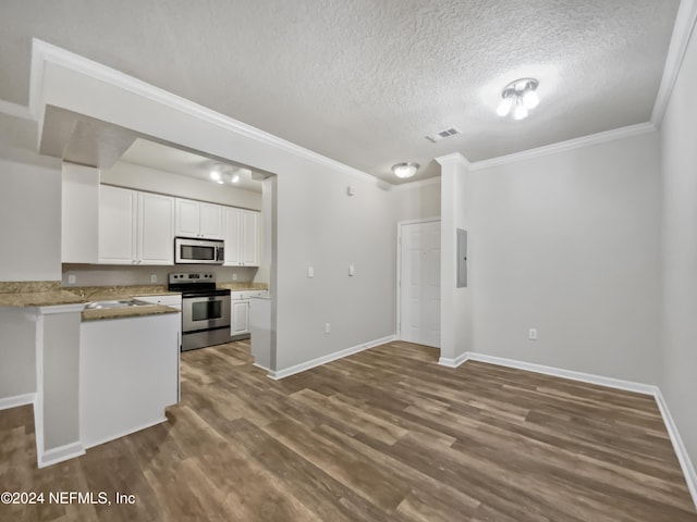 kitchen featuring hardwood / wood-style floors, ornamental molding, white cabinetry, kitchen peninsula, and stainless steel appliances