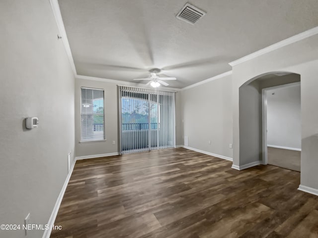 empty room featuring ceiling fan, dark hardwood / wood-style flooring, and crown molding