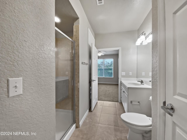 bathroom with tile patterned floors, vanity, toilet, and a shower with shower door