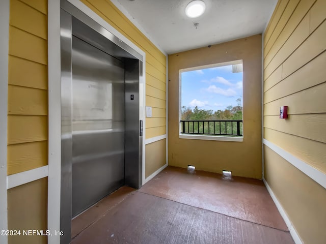 unfurnished sunroom featuring elevator