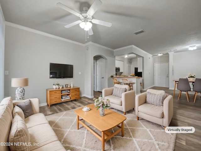 living room featuring crown molding, ceiling fan, and light wood-type flooring