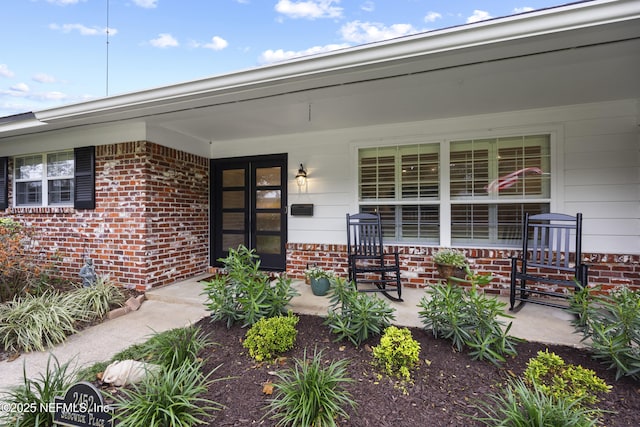 view of exterior entry featuring a porch