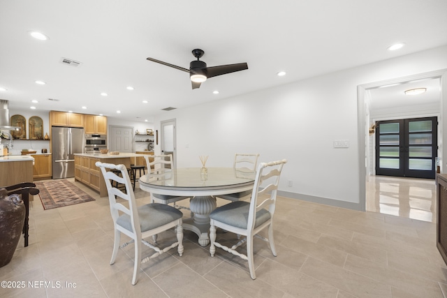 dining space with light tile patterned floors, french doors, and ceiling fan