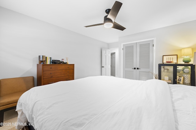 bedroom with ceiling fan and a closet