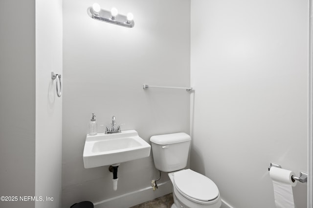 bathroom featuring toilet and sink