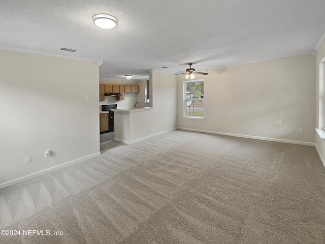 unfurnished living room with ceiling fan, light colored carpet, and a textured ceiling