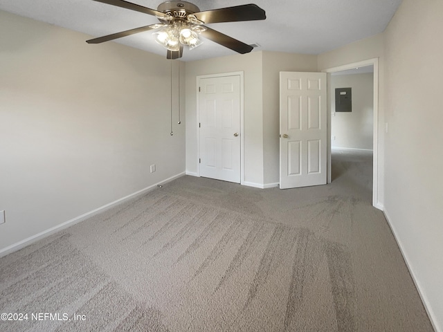 unfurnished bedroom with carpet flooring, electric panel, and ceiling fan