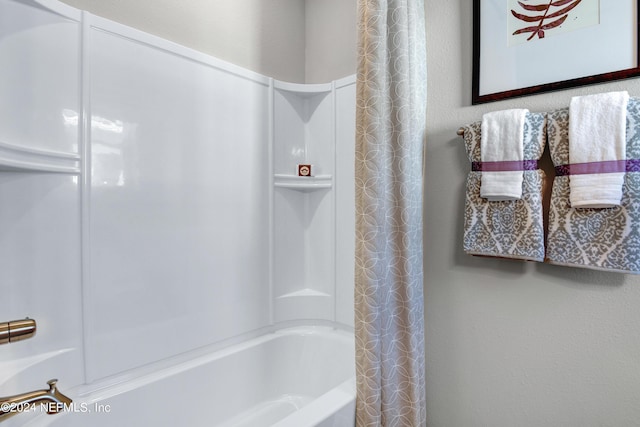 bathroom with shower / bath combination with curtain