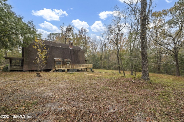 view of yard featuring a wooden deck