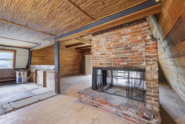 unfurnished living room with wood-type flooring, wooden ceiling, and wooden walls