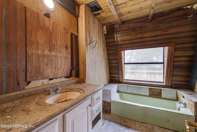 bathroom with beamed ceiling, vanity, wooden ceiling, and a tub