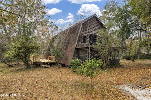 back of house featuring a deck