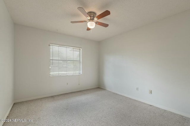 carpeted empty room with a textured ceiling and ceiling fan