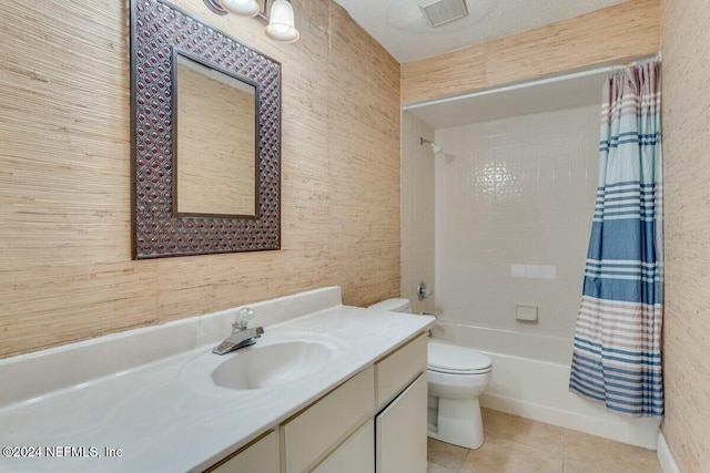 full bathroom featuring vanity, wood walls, tile patterned flooring, toilet, and shower / tub combo