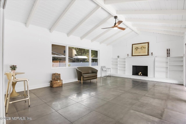 living room with vaulted ceiling with beams, a brick fireplace, and ceiling fan