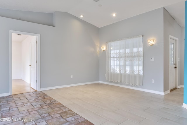 empty room with lofted ceiling