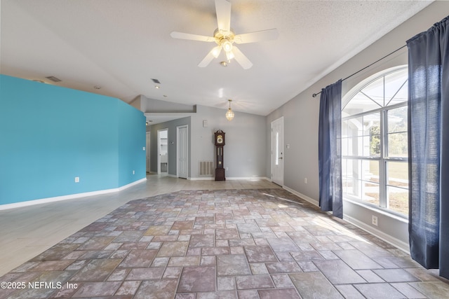 unfurnished living room with ceiling fan and lofted ceiling