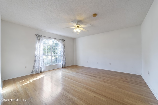 spare room with ceiling fan, a textured ceiling, and light hardwood / wood-style flooring