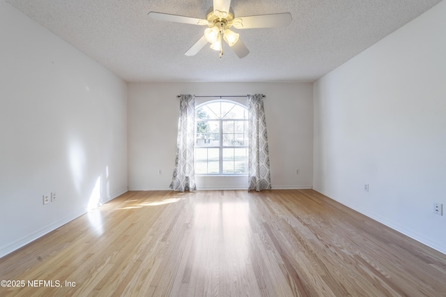 unfurnished room with a textured ceiling, ceiling fan, and light hardwood / wood-style flooring