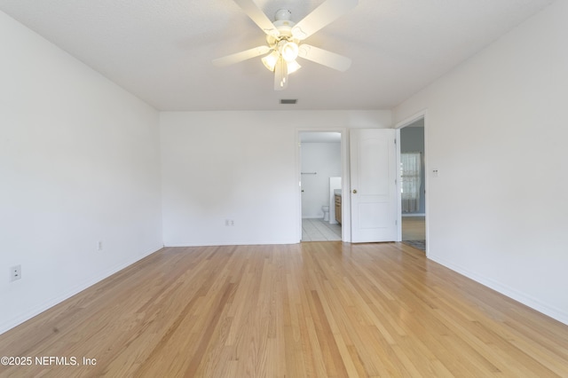 spare room featuring ceiling fan and light hardwood / wood-style flooring