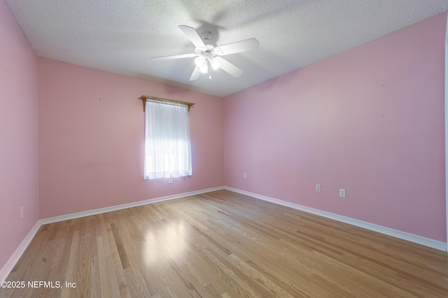 unfurnished room featuring a textured ceiling, ceiling fan, and light hardwood / wood-style floors