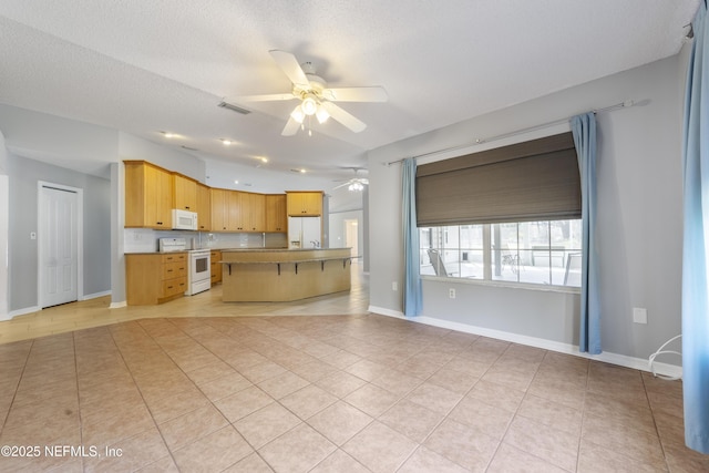 kitchen featuring light tile patterned floors, ceiling fan, backsplash, white appliances, and a textured ceiling