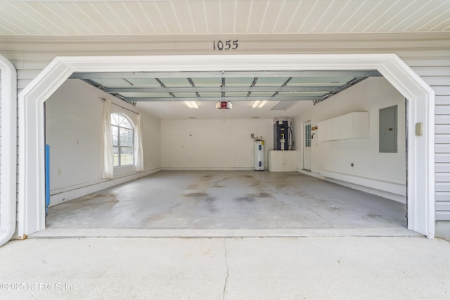 garage featuring electric panel, water heater, and a garage door opener