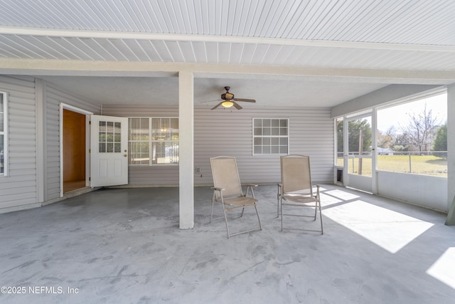 unfurnished sunroom with ceiling fan