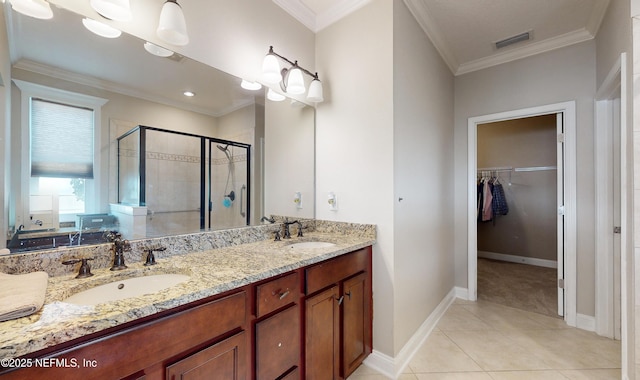 bathroom featuring vanity, tile patterned floors, an enclosed shower, and crown molding