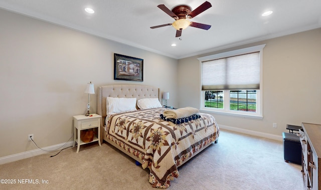 carpeted bedroom featuring ceiling fan and crown molding