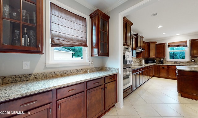 kitchen with tasteful backsplash, light stone counters, and ornamental molding