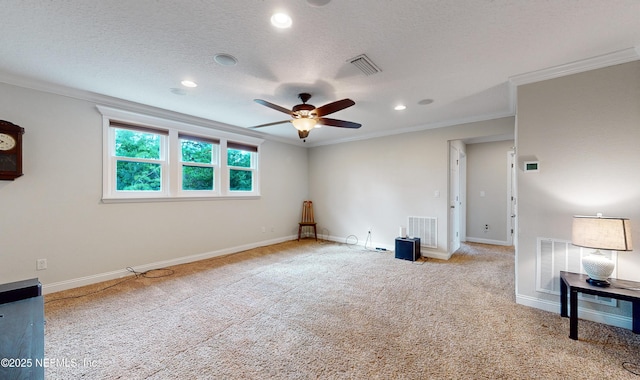 spare room with crown molding, ceiling fan, and a textured ceiling